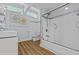 Bright bathroom with glass enclosed shower, neutral color palette, and modern fixtures at 3012 Grand View Ave, Clearwater, FL 33759