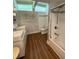 Bright bathroom with double vanity, sleek fixtures, and a glass-enclosed shower/tub combination at 3012 Grand View Ave, Clearwater, FL 33759
