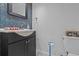 Charming bathroom featuring a modern vanity with cabinet, blue accent tile, and decorative mirror at 3012 Grand View Ave, Clearwater, FL 33759
