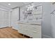 Modern bathroom featuring a double vanity, laminate floors, and neutral color palette at 3012 Grand View Ave, Clearwater, FL 33759