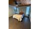 Bright bedroom featuring a wood plank ceiling, minimalist decor, and well-lit ambiance at 3012 Grand View Ave, Clearwater, FL 33759