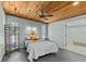 Cozy bedroom with a wood ceiling, ceiling fan, and ample natural light at 3012 Grand View Ave, Clearwater, FL 33759
