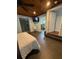 Cozy bedroom with modern flooring, a ceiling fan, and easy access to the en suite bathroom at 3012 Grand View Ave, Clearwater, FL 33759