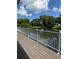 Wooden deck with a white railing, providing picturesque views of the adjacent lake at 3012 Grand View Ave, Clearwater, FL 33759