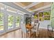 Bright dining room boasts natural light, wood floors, and access to outdoor balcony at 3012 Grand View Ave, Clearwater, FL 33759