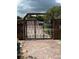 Ornate metal security gate with paved driveway and walkway at 3012 Grand View Ave, Clearwater, FL 33759