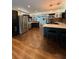 Spacious kitchen with stainless steel appliances, wood floors, and a large island at 3012 Grand View Ave, Clearwater, FL 33759