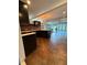 Open-concept kitchen with dark cabinets, quartz countertops, and views of the living area at 3012 Grand View Ave, Clearwater, FL 33759