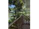 Tranquil lake view from a wooden deck surrounded by lush tropical foliage at 3012 Grand View Ave, Clearwater, FL 33759