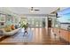 Spacious living room with views of lake, laminate floors, and comfortable seating at 3012 Grand View Ave, Clearwater, FL 33759