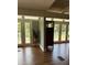 Sunlit living room with wood floors, French doors to outside deck, and great backyard views at 3012 Grand View Ave, Clearwater, FL 33759