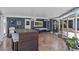Enclosed patio featuring tiled floors, a dining table, and outdoor furniture for relaxing and entertaining at 3012 Grand View Ave, Clearwater, FL 33759