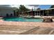 Outdoor swimming pool with rock feature, tile patio, and views of the backyard at 3012 Grand View Ave, Clearwater, FL 33759