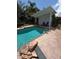 Beautiful pool with brick patio, built in rock waterfall, and lounge chairs at 3012 Grand View Ave, Clearwater, FL 33759