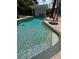 Bright pool with a stone waterfall feature and a spacious deck at 3012 Grand View Ave, Clearwater, FL 33759