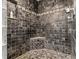 Custom tiled shower with a corner seat and decorative tile border at 3012 Grand View Ave, Clearwater, FL 33759