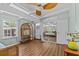 Bright sun room with vaulted ceilings, wood laminate flooring, day bed and built-in shelves at 3012 Grand View Ave, Clearwater, FL 33759