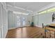 Bright sun room with exposed ceiling beams, wood laminate floors, and outdoor access at 3012 Grand View Ave, Clearwater, FL 33759