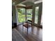 Bright sunroom with scenic lake views, wood floors, and great natural light at 3012 Grand View Ave, Clearwater, FL 33759