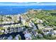 Expansive aerial view of a waterfront community, showcasing canals, homes, and access to the open bay at 304 Westwinds Dr, Palm Harbor, FL 34683