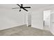 Clean bedroom features neutral carpet, a ceiling fan, and a walk-in closet at 304 Westwinds Dr, Palm Harbor, FL 34683