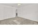 Spacious bedroom features neutral carpeting and access to a closet and other rooms at 304 Westwinds Dr, Palm Harbor, FL 34683