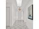 Bright foyer with geometric tile flooring, a skylight, and crisp white walls, creating an inviting entrance at 304 Westwinds Dr, Palm Harbor, FL 34683