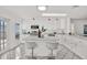 A bright, all-white kitchen featuring sleek countertops, modern appliances, and a central island with seating at 304 Westwinds Dr, Palm Harbor, FL 34683