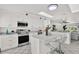 Bright white kitchen with modern appliances, sleek countertops, and a central island, creating a stylish and functional space at 304 Westwinds Dr, Palm Harbor, FL 34683