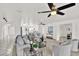 Bright living room with neutral walls, plush seating, and large ceiling fans, creating an inviting and airy atmosphere at 304 Westwinds Dr, Palm Harbor, FL 34683