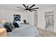 Well-lit main bedroom features a modern ceiling fan and an attached bathroom at 304 Westwinds Dr, Palm Harbor, FL 34683