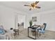 Home office includes modern ceiling fan and a view into the living room at 304 Westwinds Dr, Palm Harbor, FL 34683