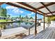 A scenic view from a covered patio overlooking a serene canal with boats and docks, offering a tranquil waterfront lifestyle at 304 Westwinds Dr, Palm Harbor, FL 34683