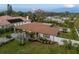 Aerial shot of the home showcasing the well-maintained lawn, landscaping, and privacy fence at 309 Palmetto Ln, Largo, FL 33770