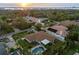 Aerial view of the property highlighting its backyard pool, mature trees, and neighborhood setting at 309 Palmetto Ln, Largo, FL 33770
