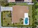Aerial view showcases a home with a private backyard swimming pool, well-maintained lawn, and driveway at 309 Palmetto Ln, Largo, FL 33770