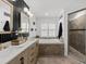 This bathroom offers double vanities, a soaking tub, a walk-in shower, and modern finishes at 309 Palmetto Ln, Largo, FL 33770