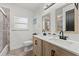 Bathroom with a double vanity, black faucet hardware, and a large mirror at 309 Palmetto Ln, Largo, FL 33770