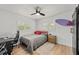 Bedroom with light-colored wood flooring, natural light, and a mounted surfboard at 309 Palmetto Ln, Largo, FL 33770