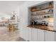 Coffee bar with wooden shelving, beverage cooler, and white cabinetry at 309 Palmetto Ln, Largo, FL 33770