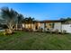 Charming home exterior with a lush lawn, landscaped garden beds and lovely curb appeal at 309 Palmetto Ln, Largo, FL 33770