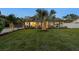 Beautiful home with manicured lawn, lush landscaping, and an inviting exterior design at twilight at 309 Palmetto Ln, Largo, FL 33770