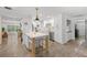 Bright kitchen featuring white cabinets, stainless steel appliances, and a center island with seating at 309 Palmetto Ln, Largo, FL 33770