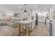 Open floor plan with kitchen island, white marble countertop, and tile flooring at 309 Palmetto Ln, Largo, FL 33770