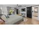 This is a spacious main bedroom with a sliding glass door to the outdoor living space and en suite bath at 309 Palmetto Ln, Largo, FL 33770
