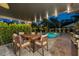 Charming outdoor dining area with a wood table, covered patio, and a view of the refreshing pool at 309 Palmetto Ln, Largo, FL 33770