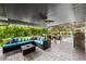 This outdoor living space offers a dining space, lounge area, and stainless steel grill at 309 Palmetto Ln, Largo, FL 33770