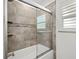 Featuring a tub with shower combination and modern tile detail, this bathroom is sure to please at 309 Palmetto Ln, Largo, FL 33770