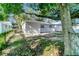View of the home's backyard and patio area surrounded by mature shade trees at 3111 W Douglas St, Tampa, FL 33607