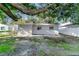 A backyard view showcases the property's back wall and concrete patio at 3111 W Douglas St, Tampa, FL 33607